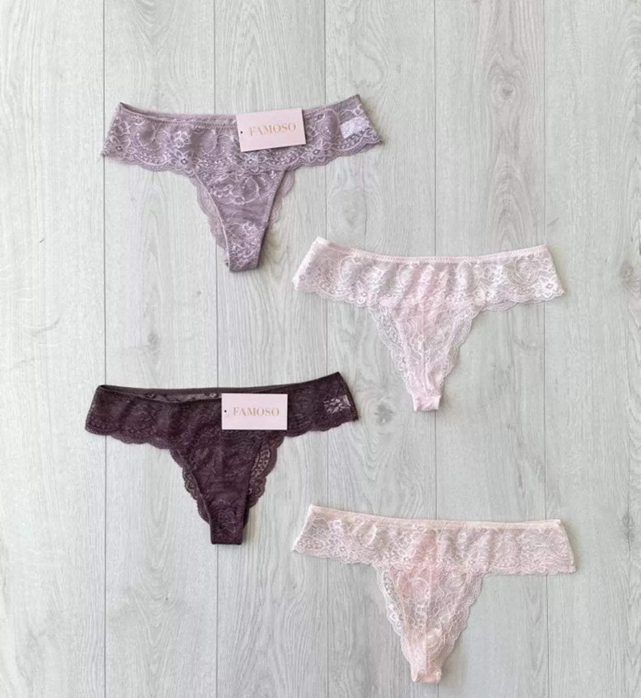 Four pairs of lace underwear on a light wooden surface with 'FAVORITE' branding.
