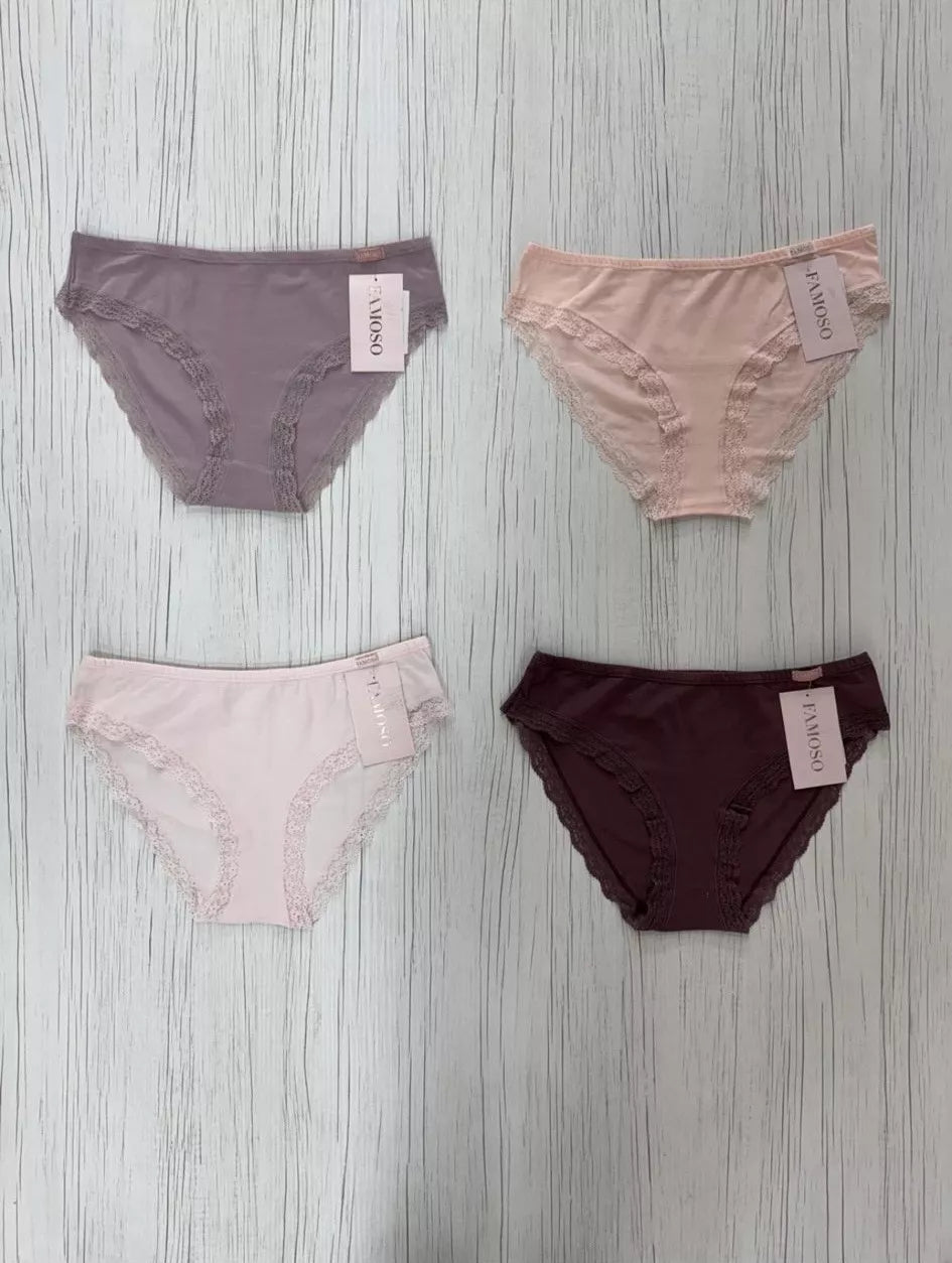 Four pairs of women's underwear in different colors on a wooden surface.