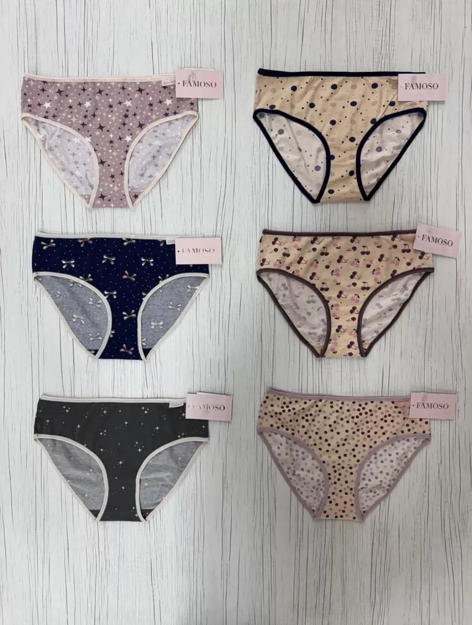 Set of women's underwear with various patterns on a wooden surface
