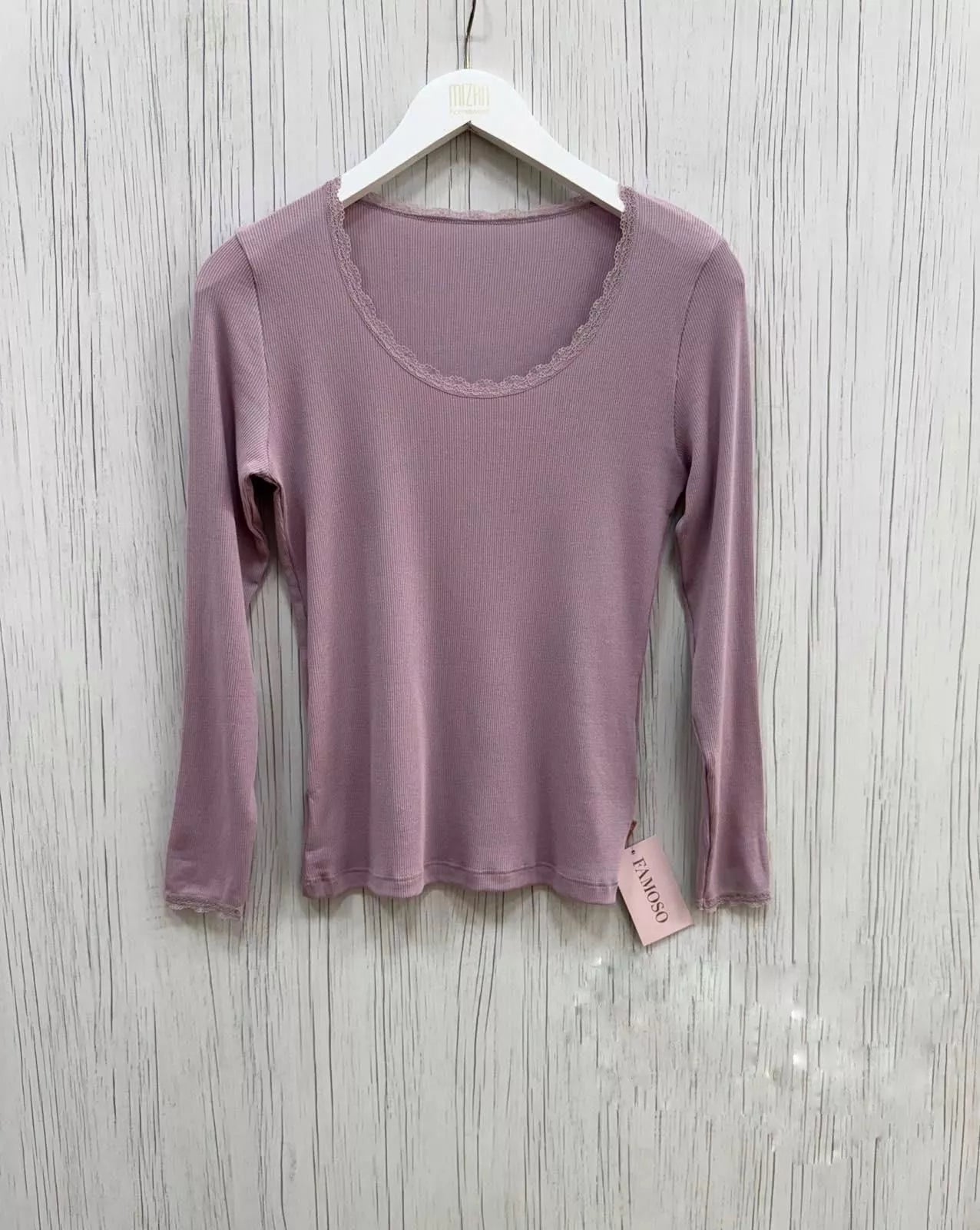 Purple long-sleeve shirt on a hanger against a wooden background