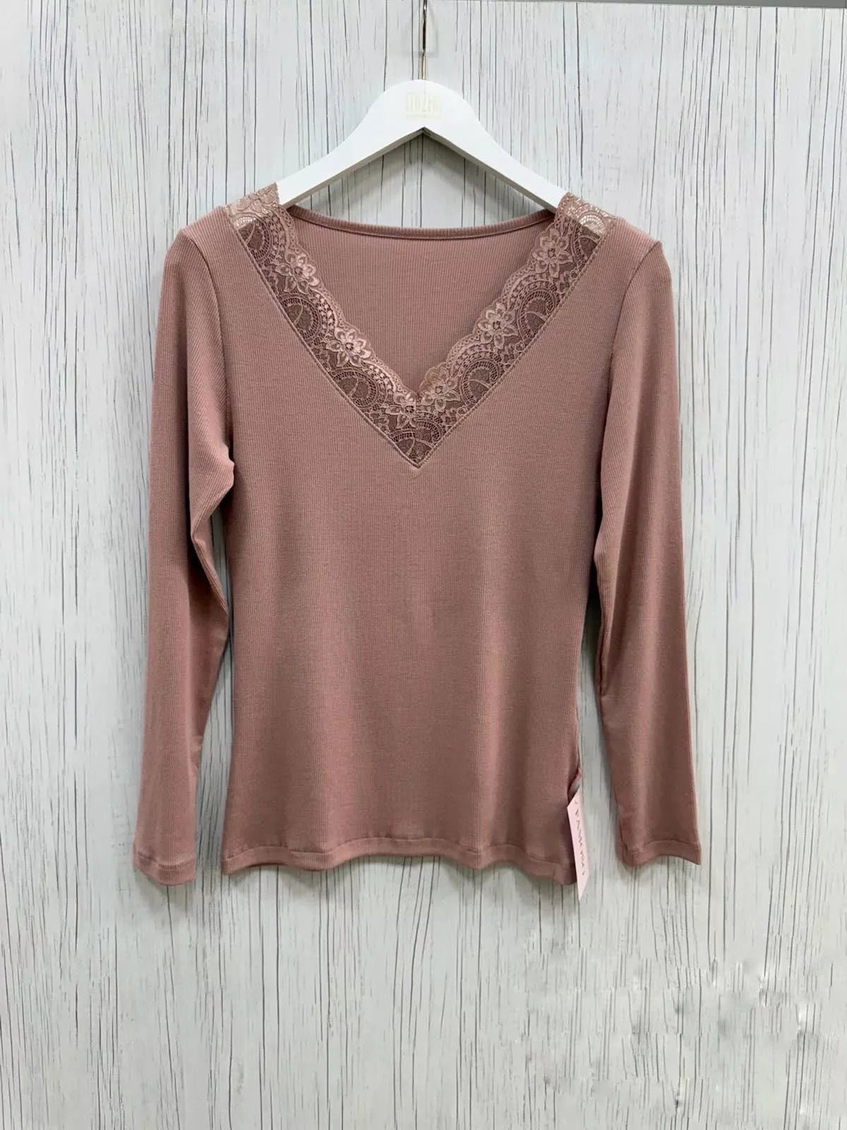 Brown long-sleeve top with lace detail on a wooden surface